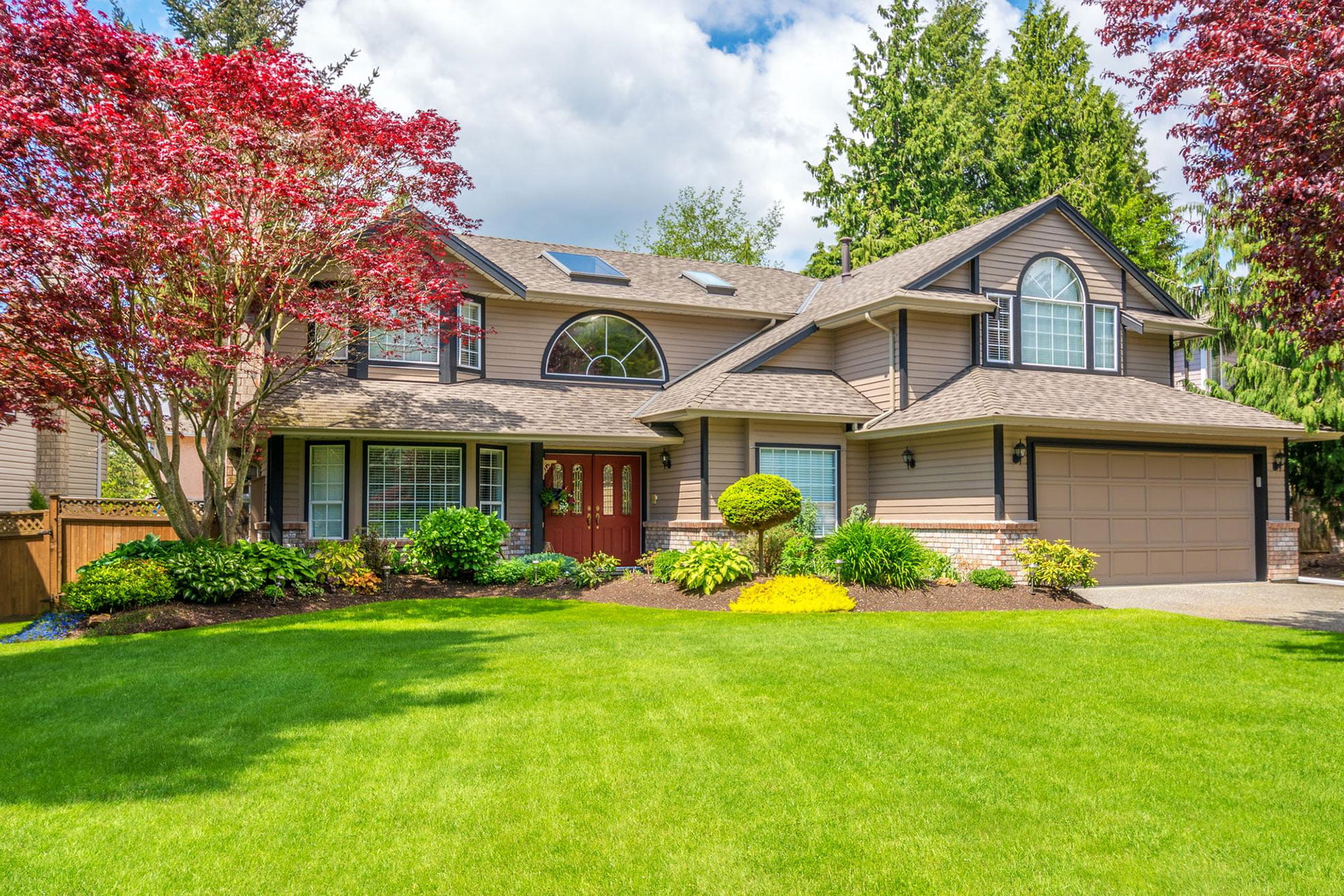 luxury house with beautiful landscaping sunny day home exterior